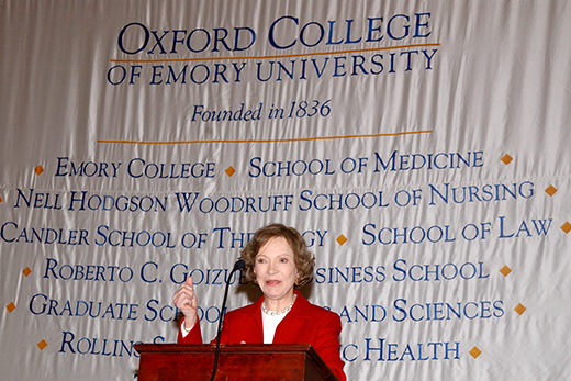 Image of Rosalynn Carter speaking at a podium on the Oxford College campus.